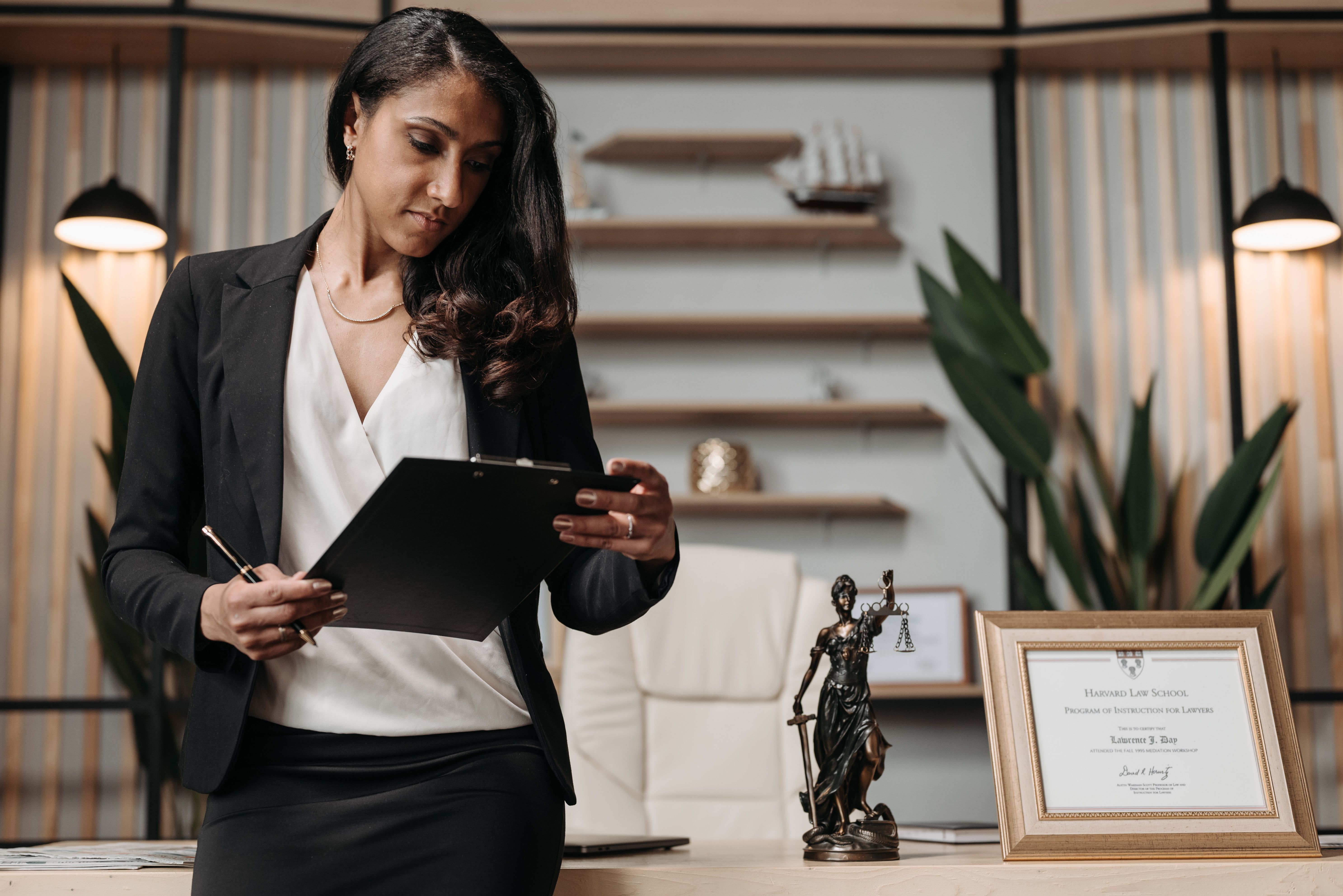 Confident businesswoman reviewing legal paperwork in a modern law office funded by a litigation financier