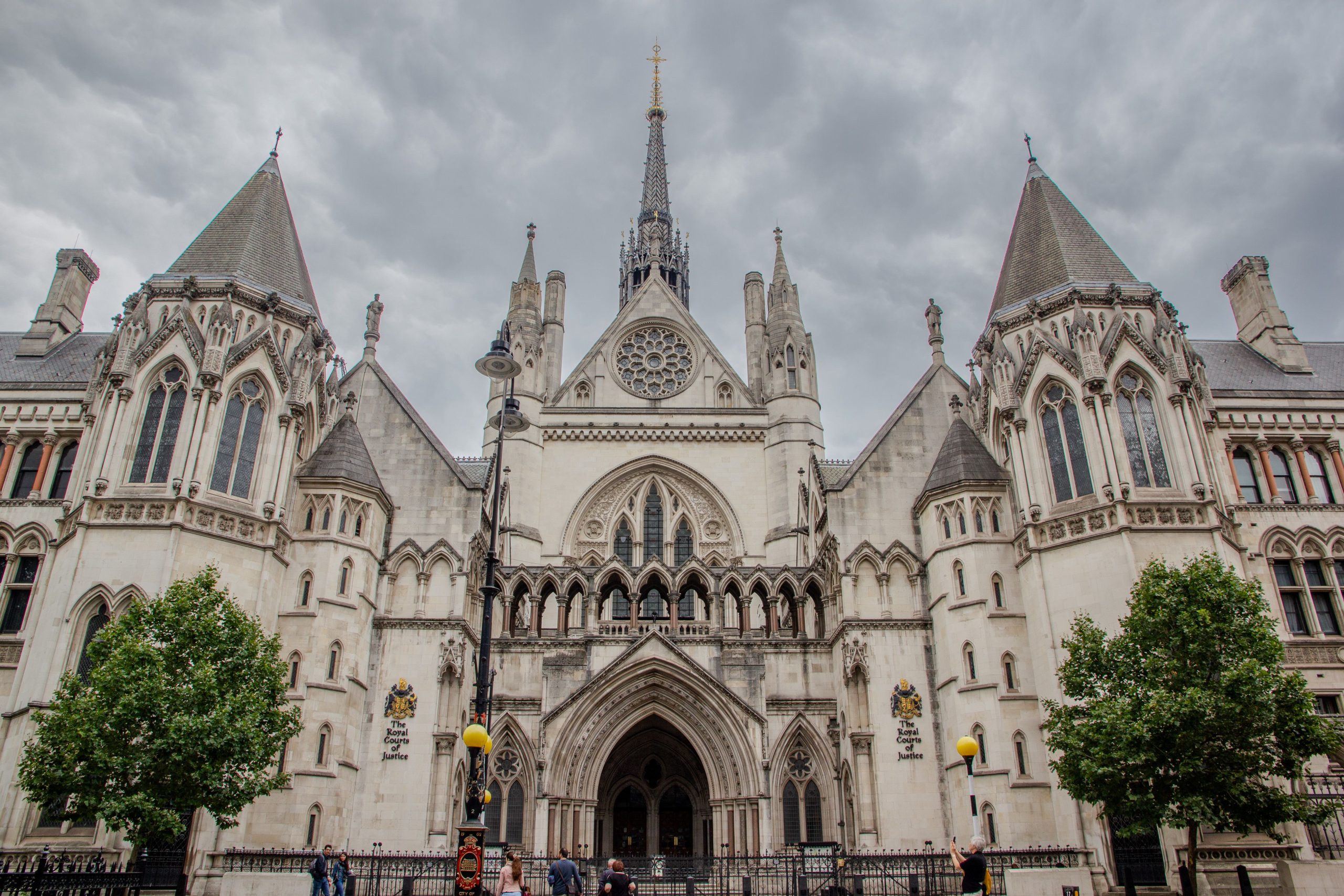 Exterior of the Royal Courts of Justice in London under cloudy skies, home to some of Britain's biggest lawsuits