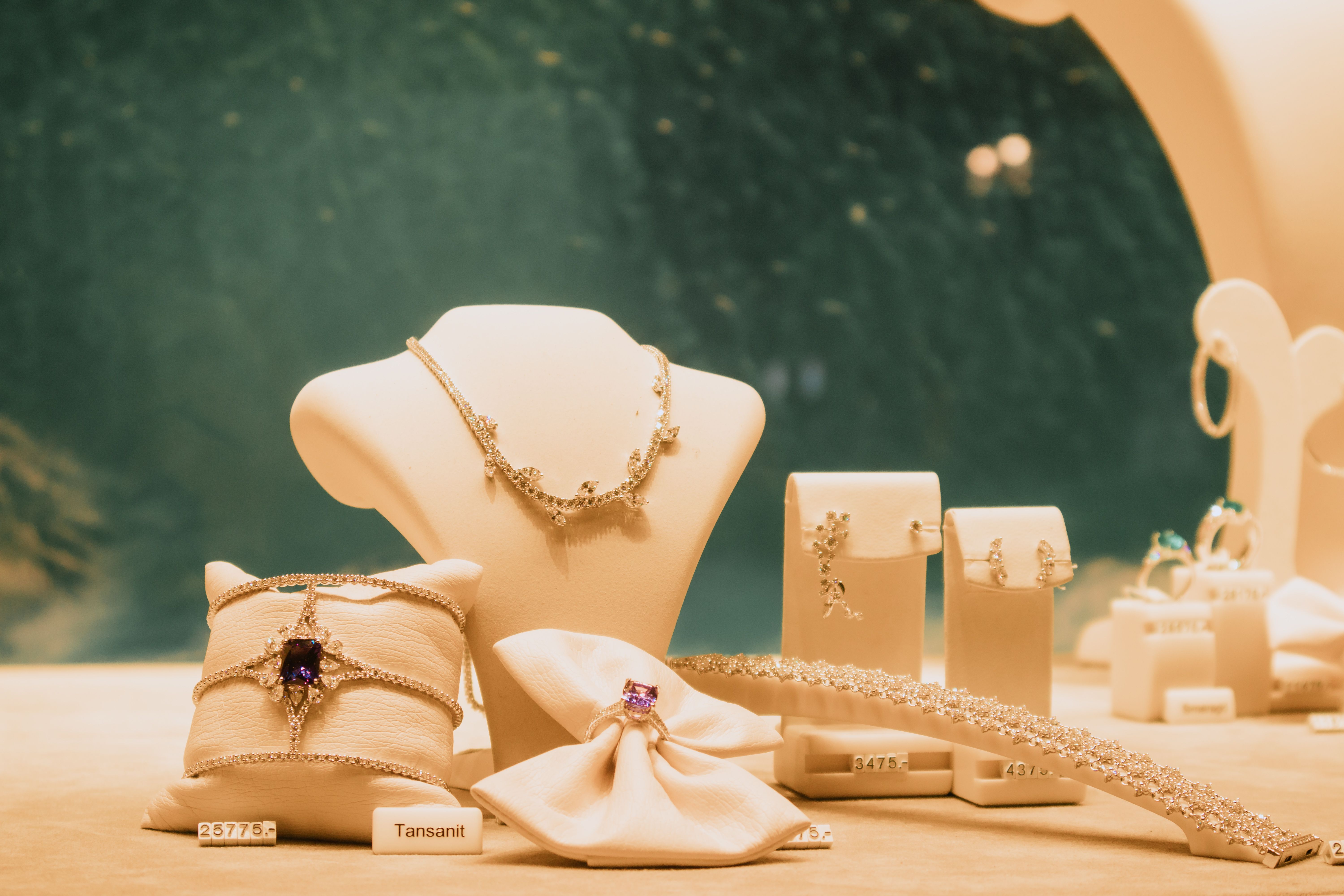 Luxury jewelry set displayed with necklaces and rings in a premium store setting
