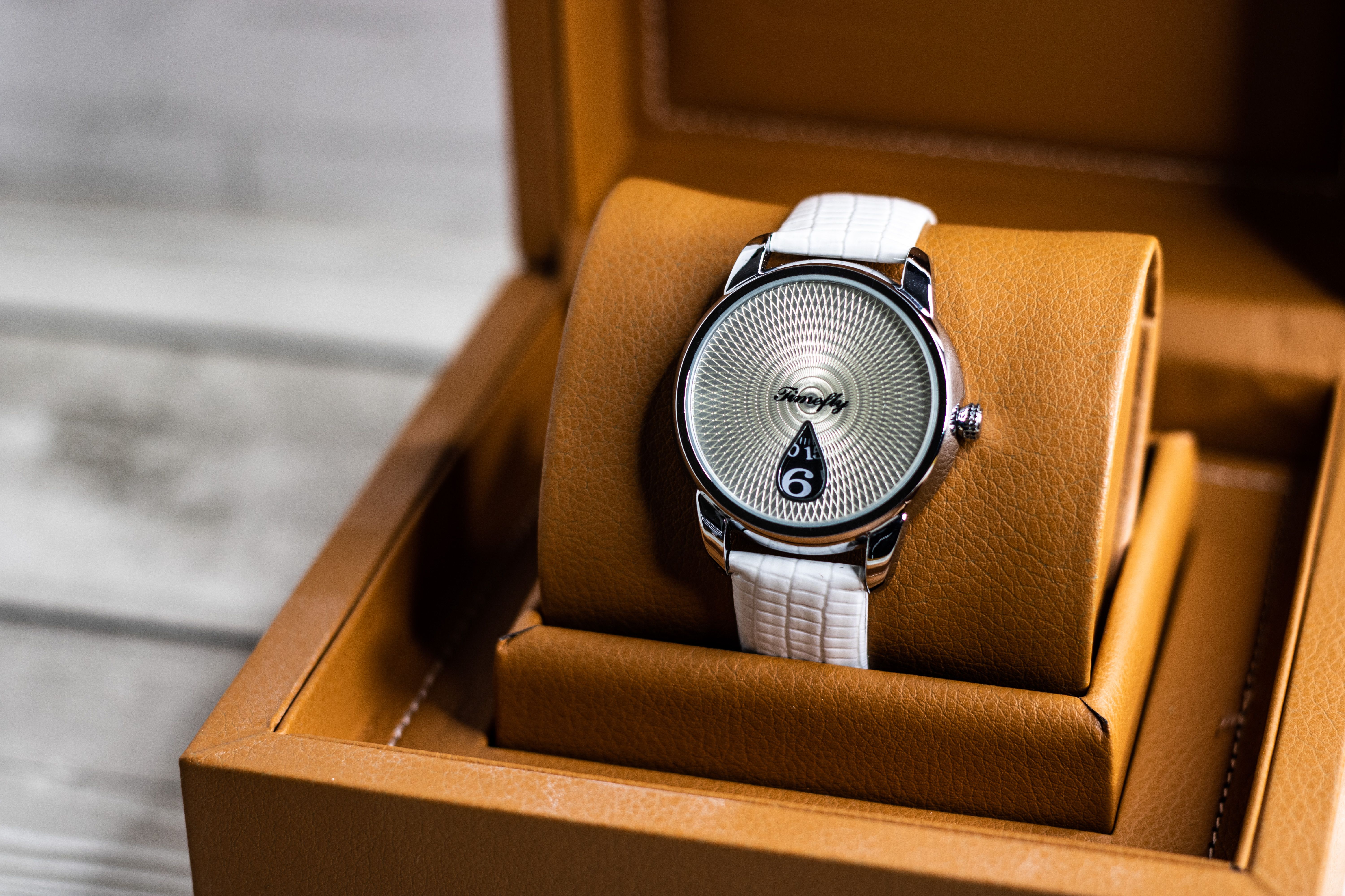 Luxury wristwatch presented in a brown leather box